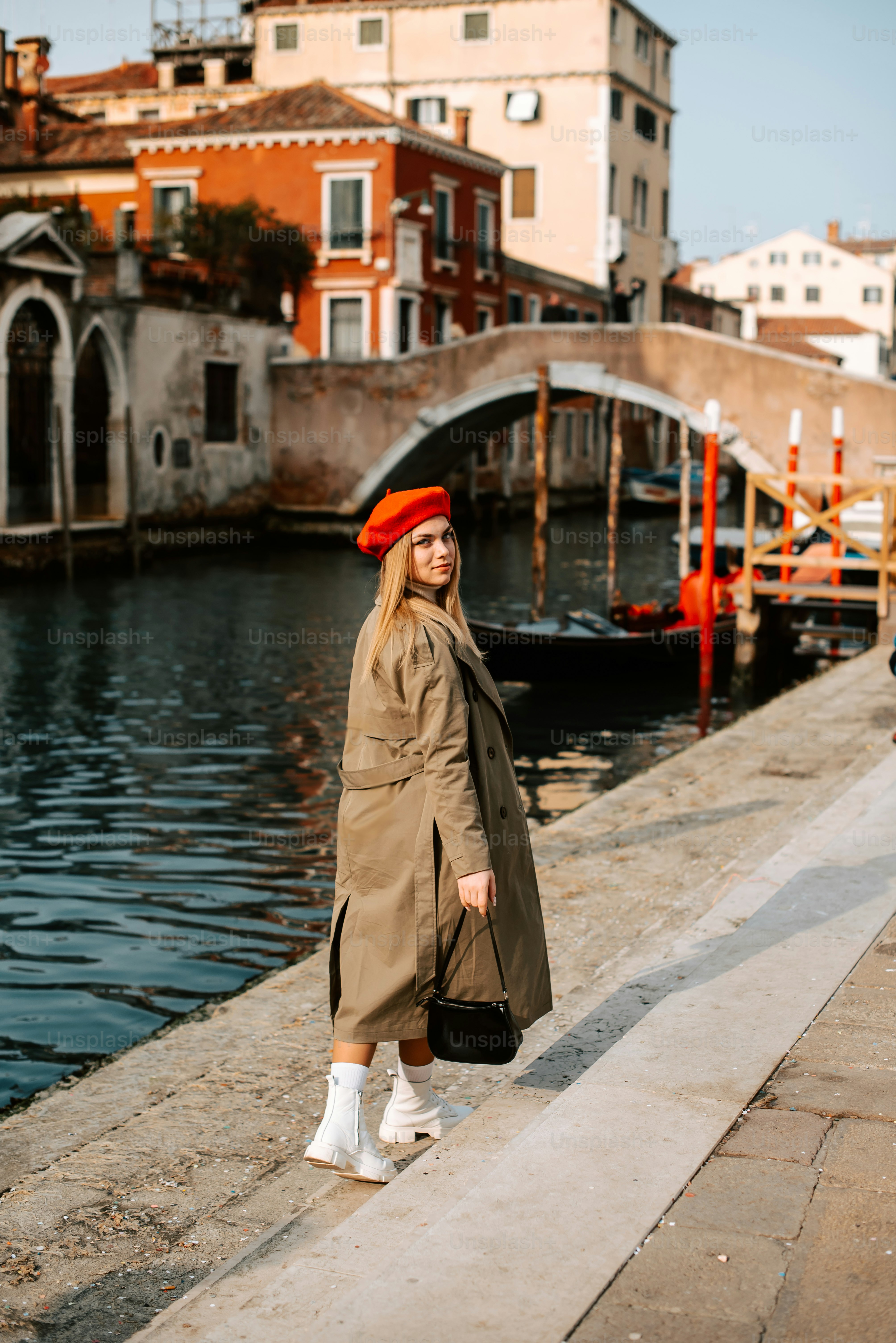 a woman standing on the side of a river