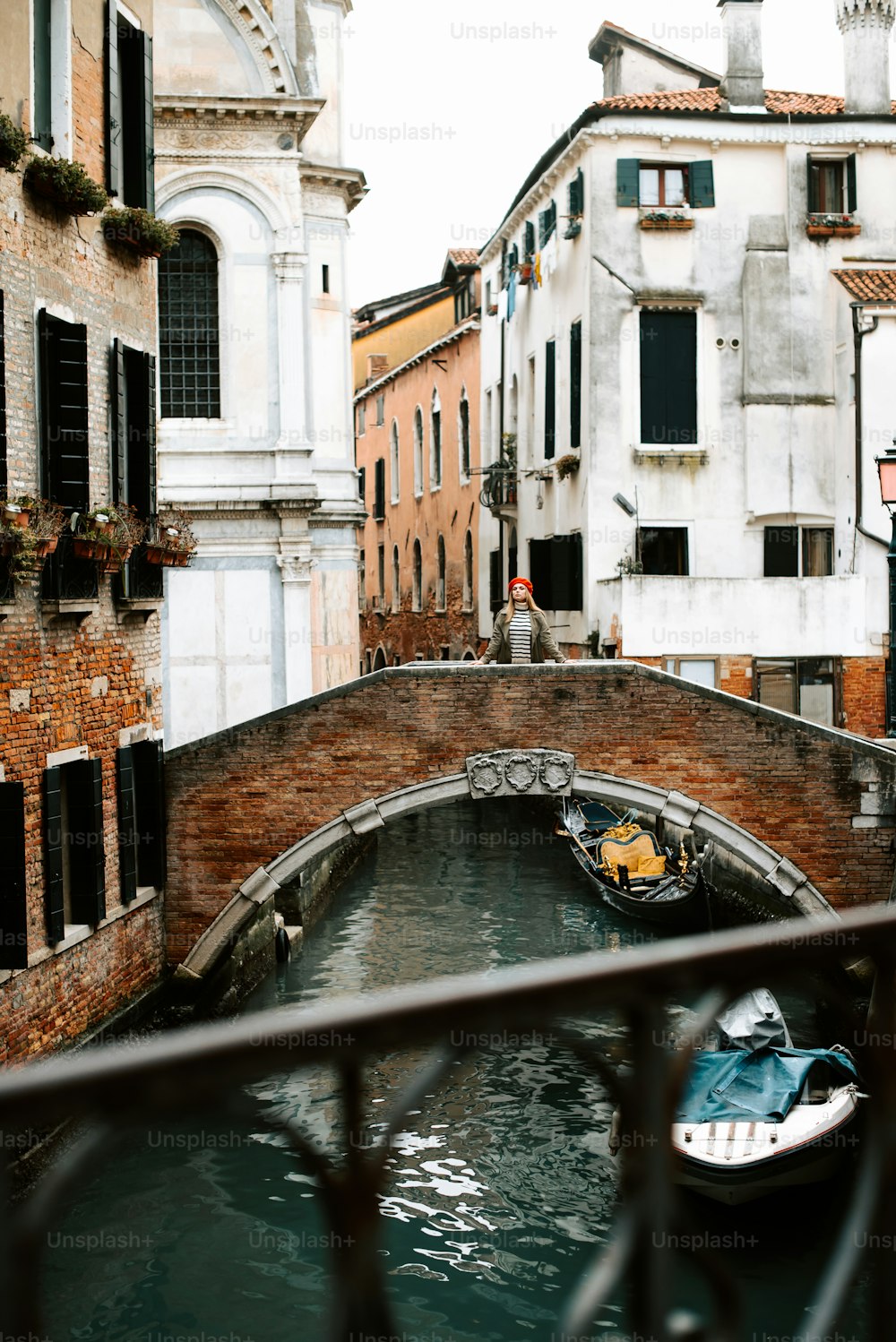 a bridge over a canal with boats in it