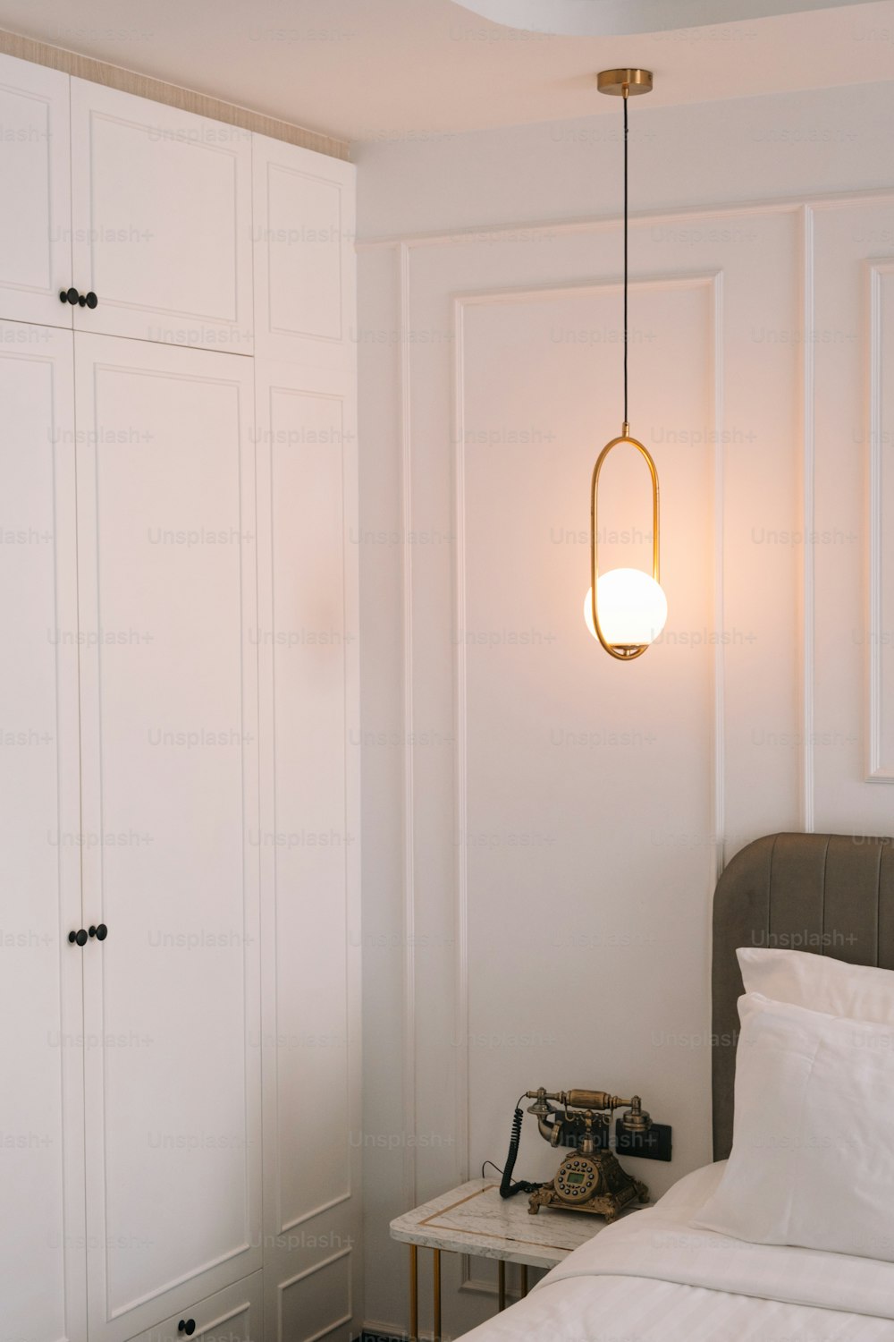 a bedroom with white walls and a bed