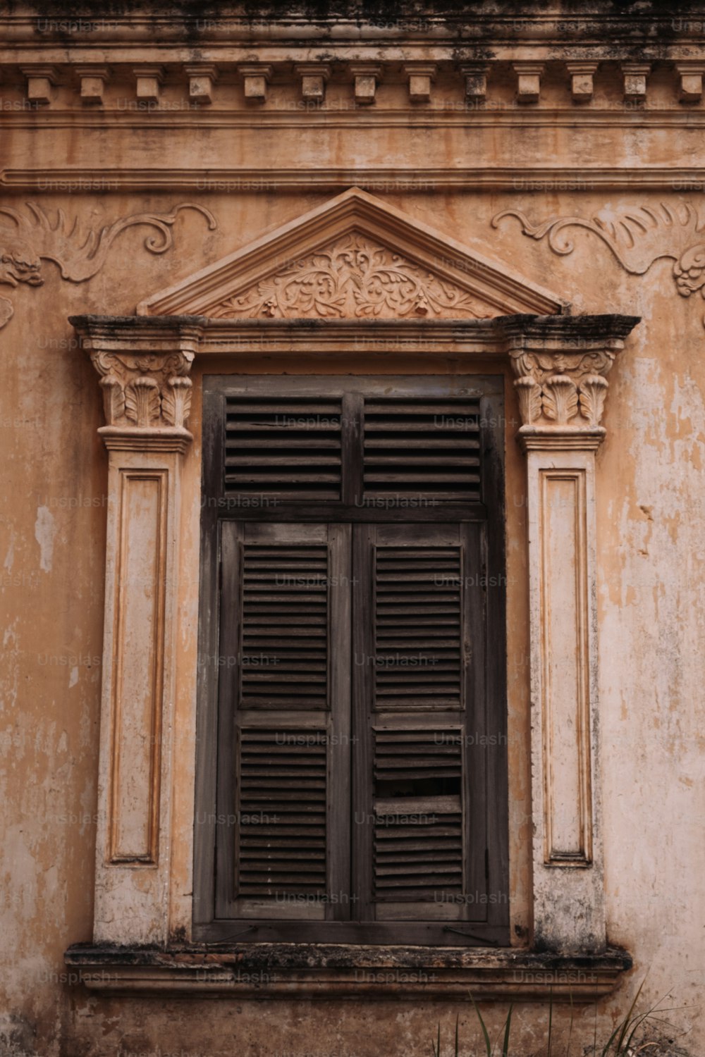an old building with a window and shutters