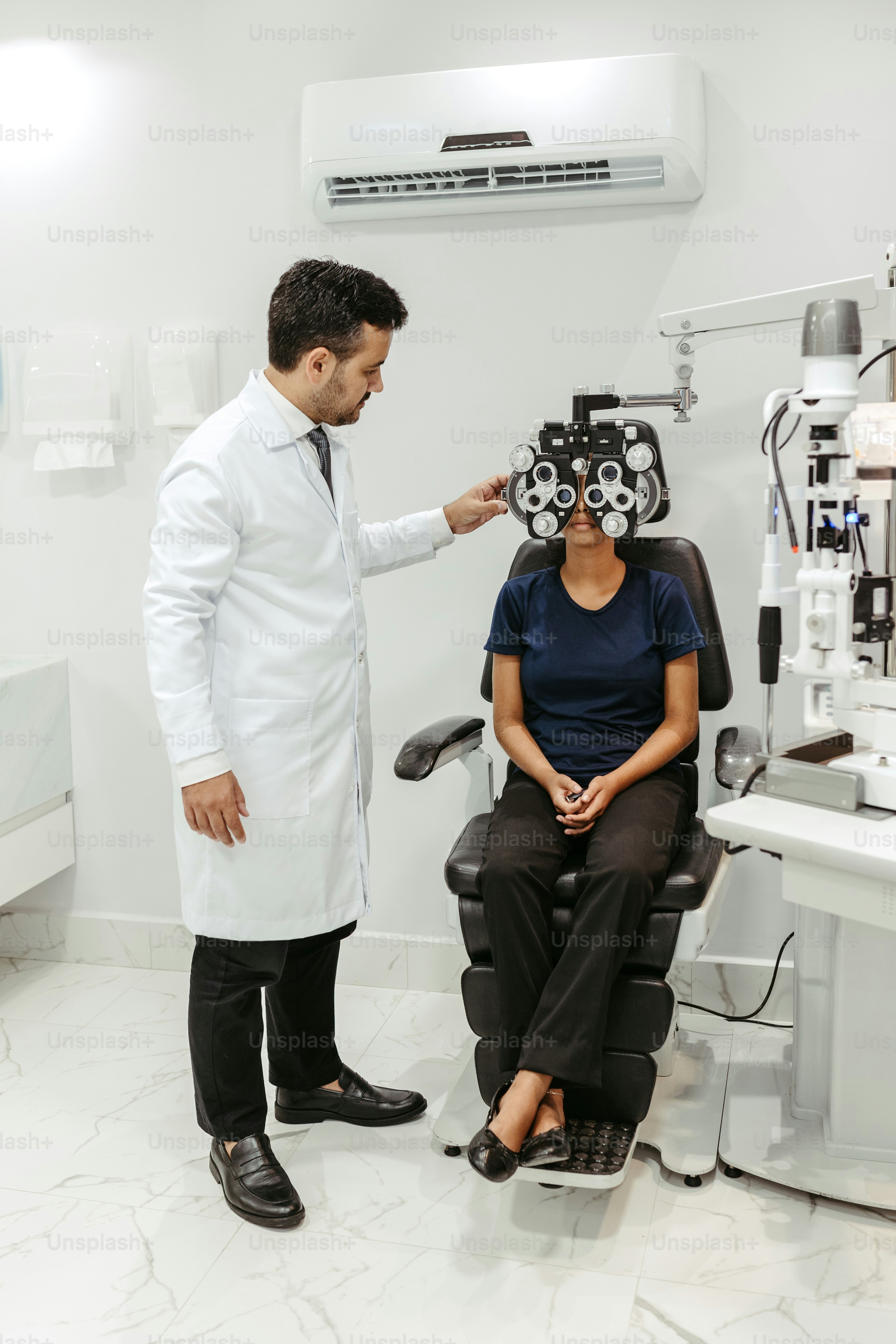 a doctor examines a patient's teeth in a dental office