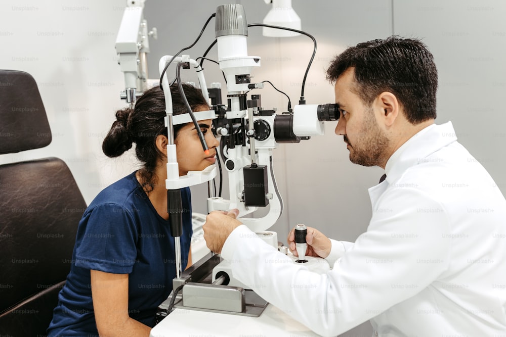 a woman getting her eye examined by a doctor