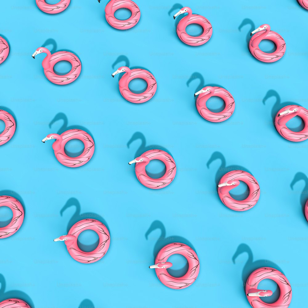 a group of pink donuts sitting on top of a blue surface