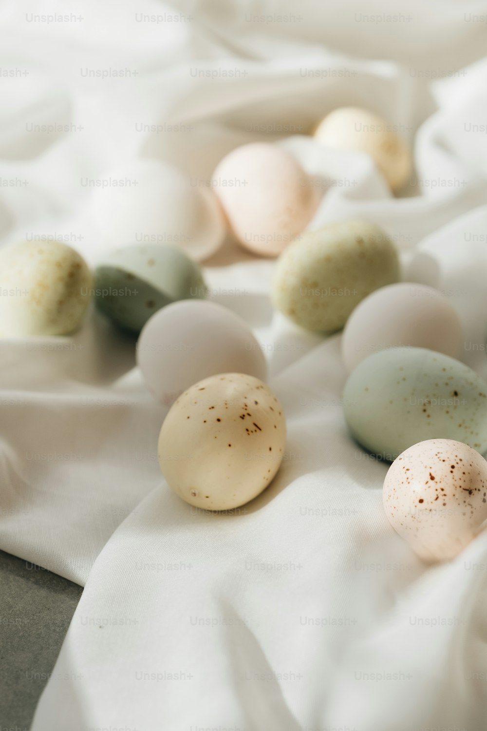 a close up of a bunch of eggs on a bed