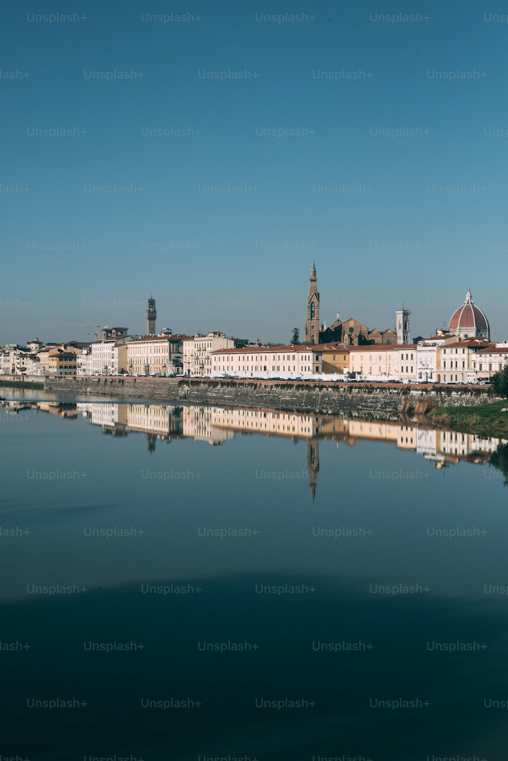 a body of water with buildings in the background