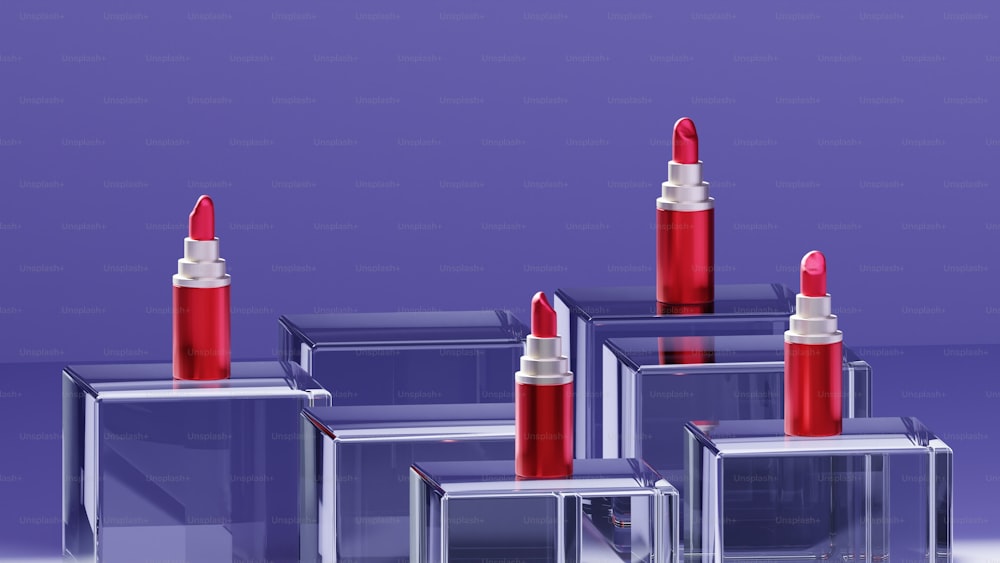 a group of four red lipsticks sitting on top of each other