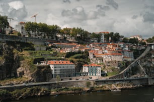 a city on a hill with a bridge going over it