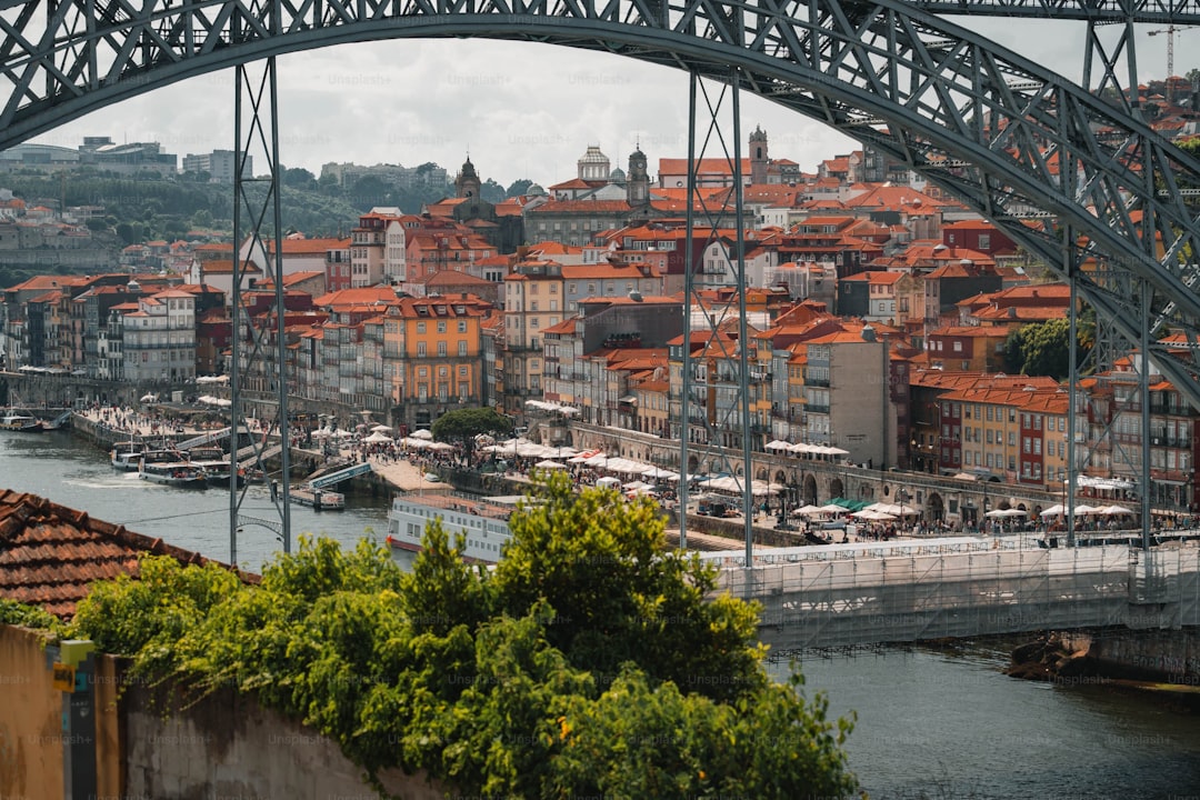 a bridge over a body of water with a city in the background