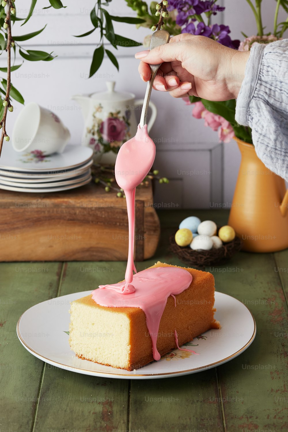 a piece of cake with pink icing on a plate