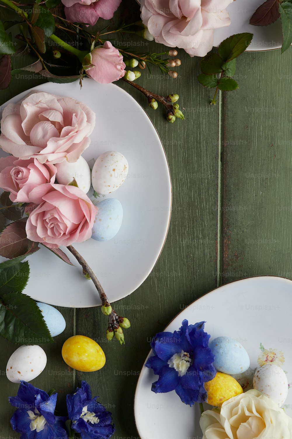 two plates with flowers and eggs on them