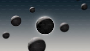 a group of black balls floating in the air