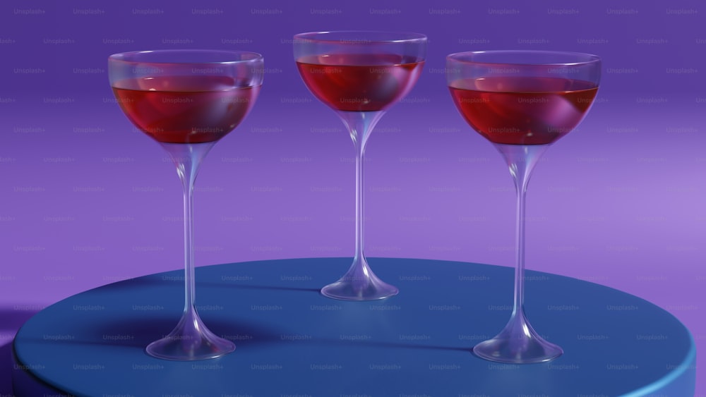 three glasses of wine sitting on a table