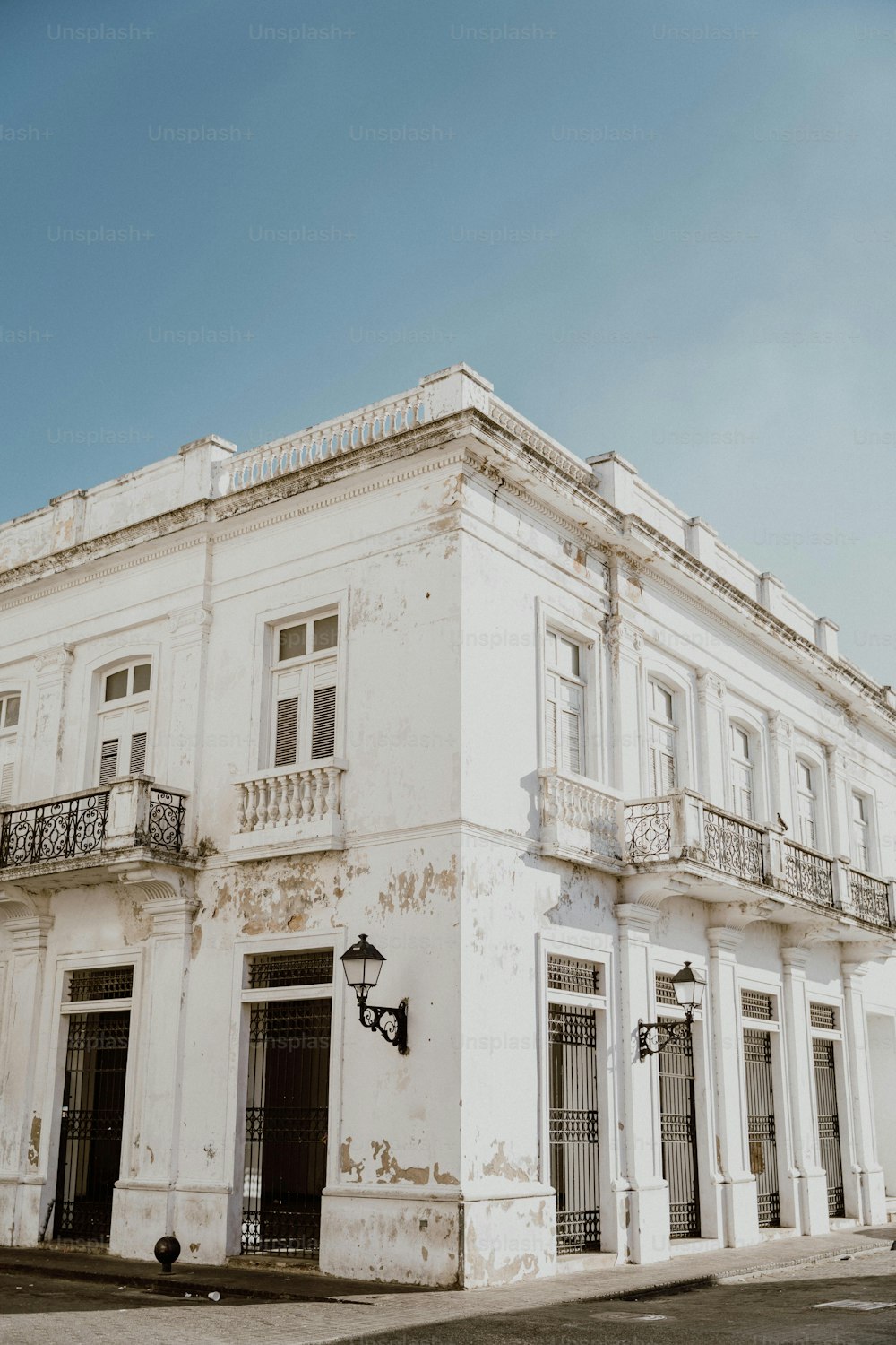 a large white building with a balcony and balconies