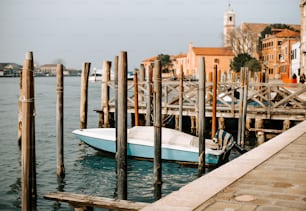 a blue and white boat docked at a pier