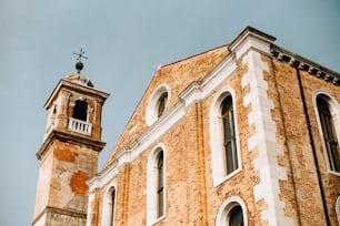 a tall brick building with a clock tower