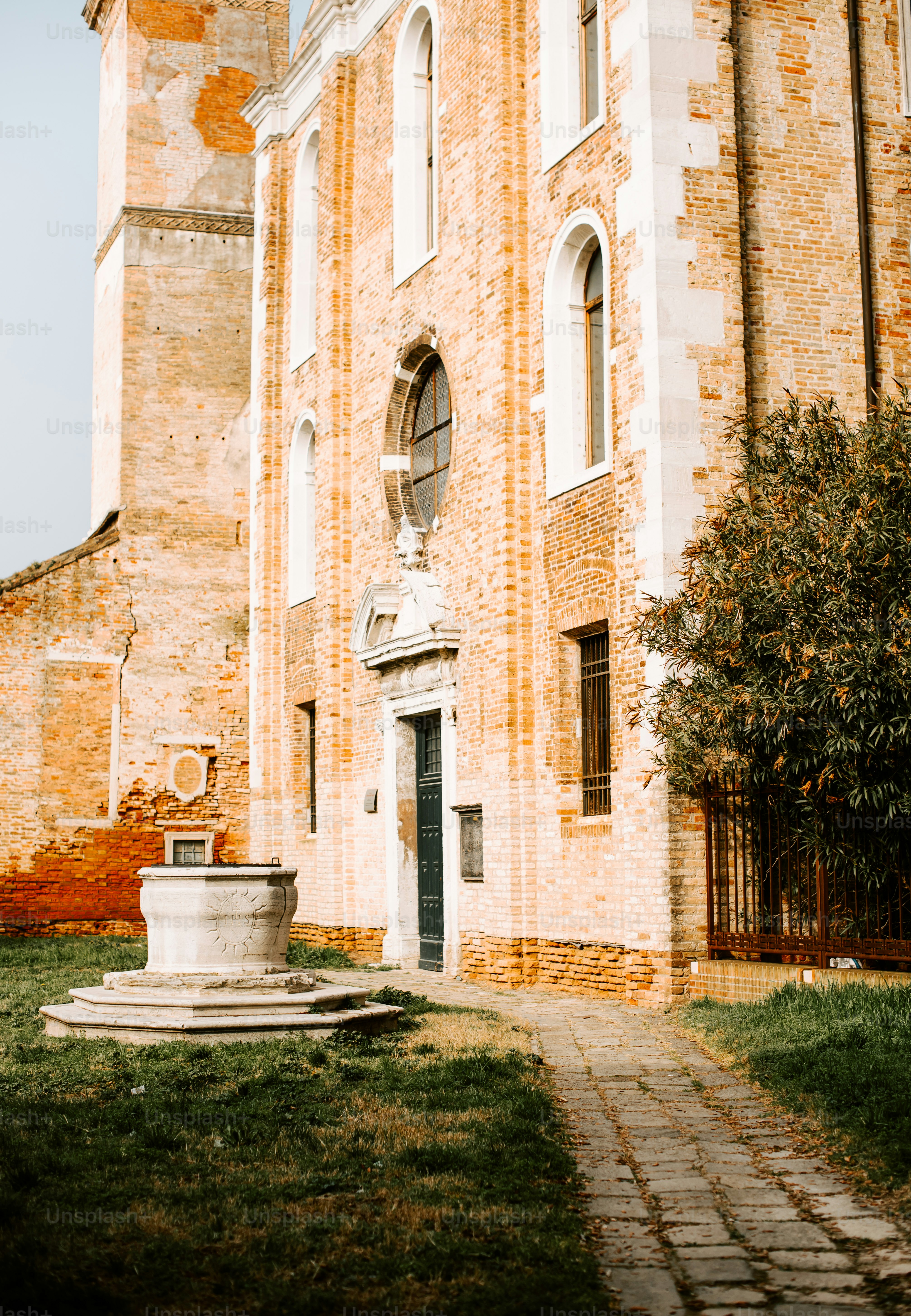 a large brick building with a fountain in front of it