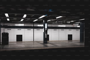 a subway station with a black and white tiled floor