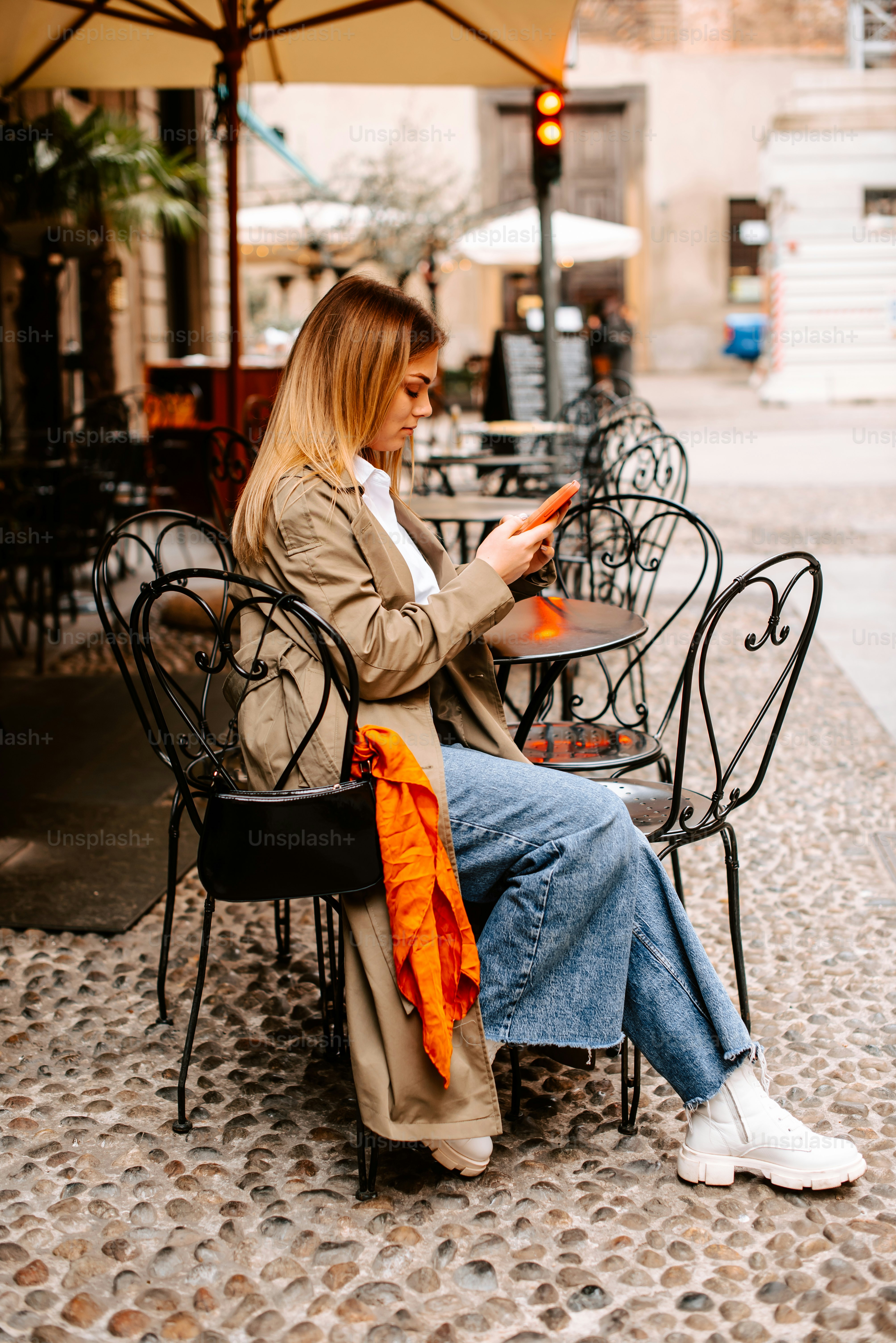a woman is sitting on a chair outside
