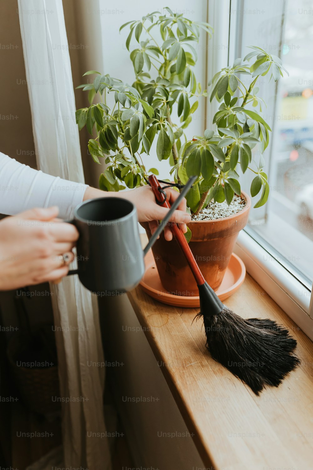 a woman is holding a cup and a broom