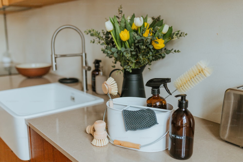 a kitchen counter with a sink, soap dispenser, soap brush,
