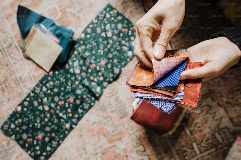 a person putting a piece of cloth on top of a piece of cloth