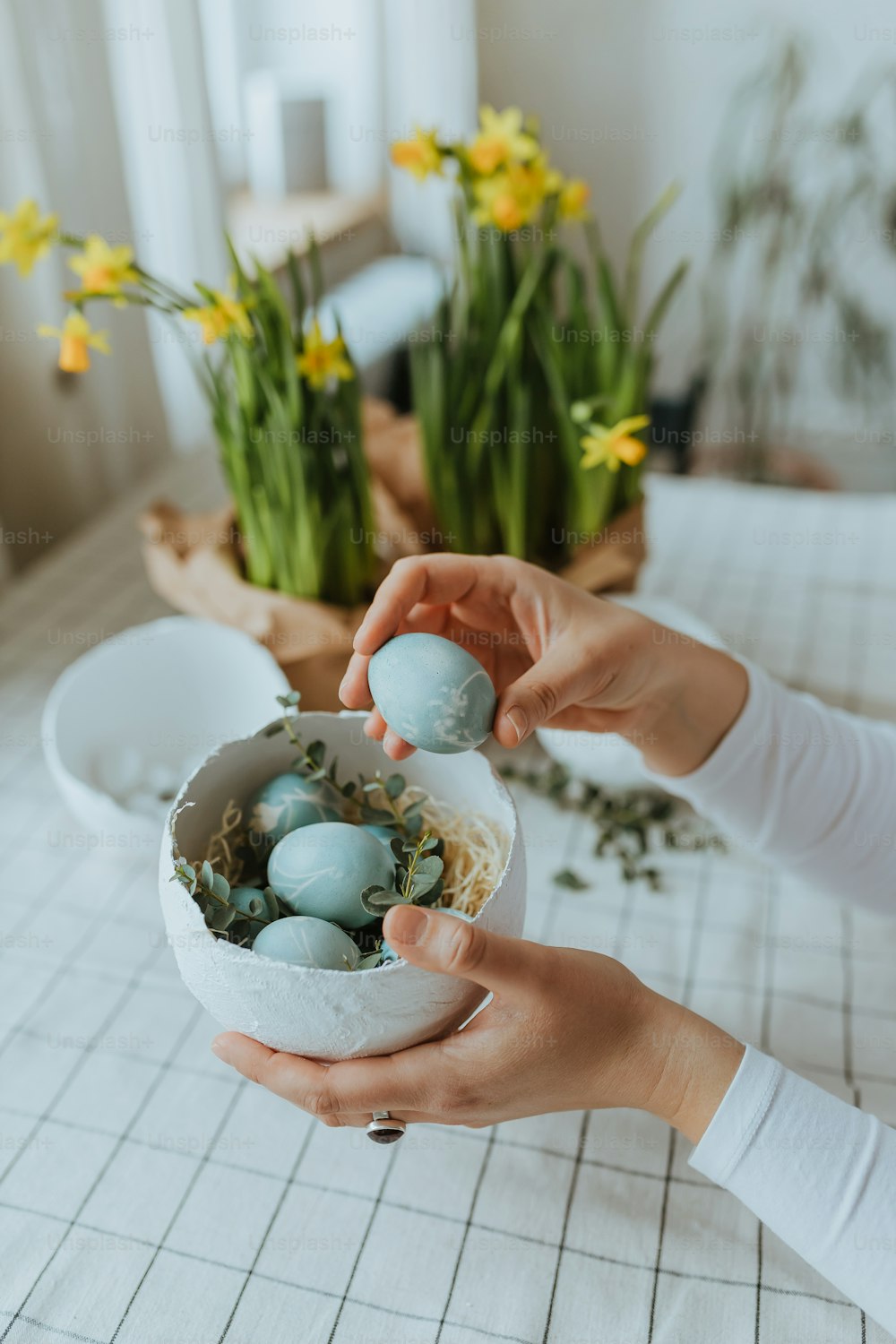 a person holding a bowl filled with eggs