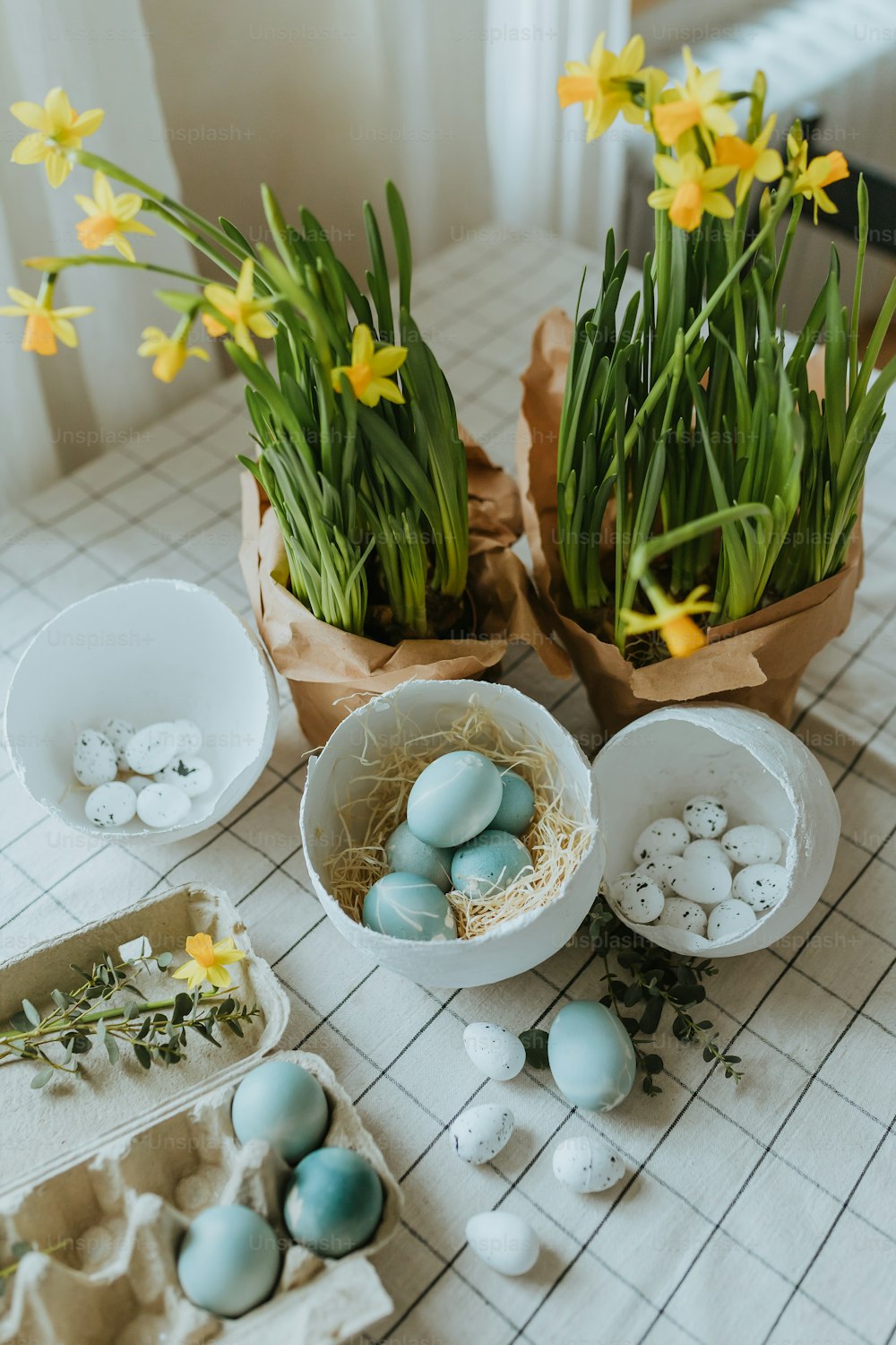 a table topped with eggs and flowers on top of a table