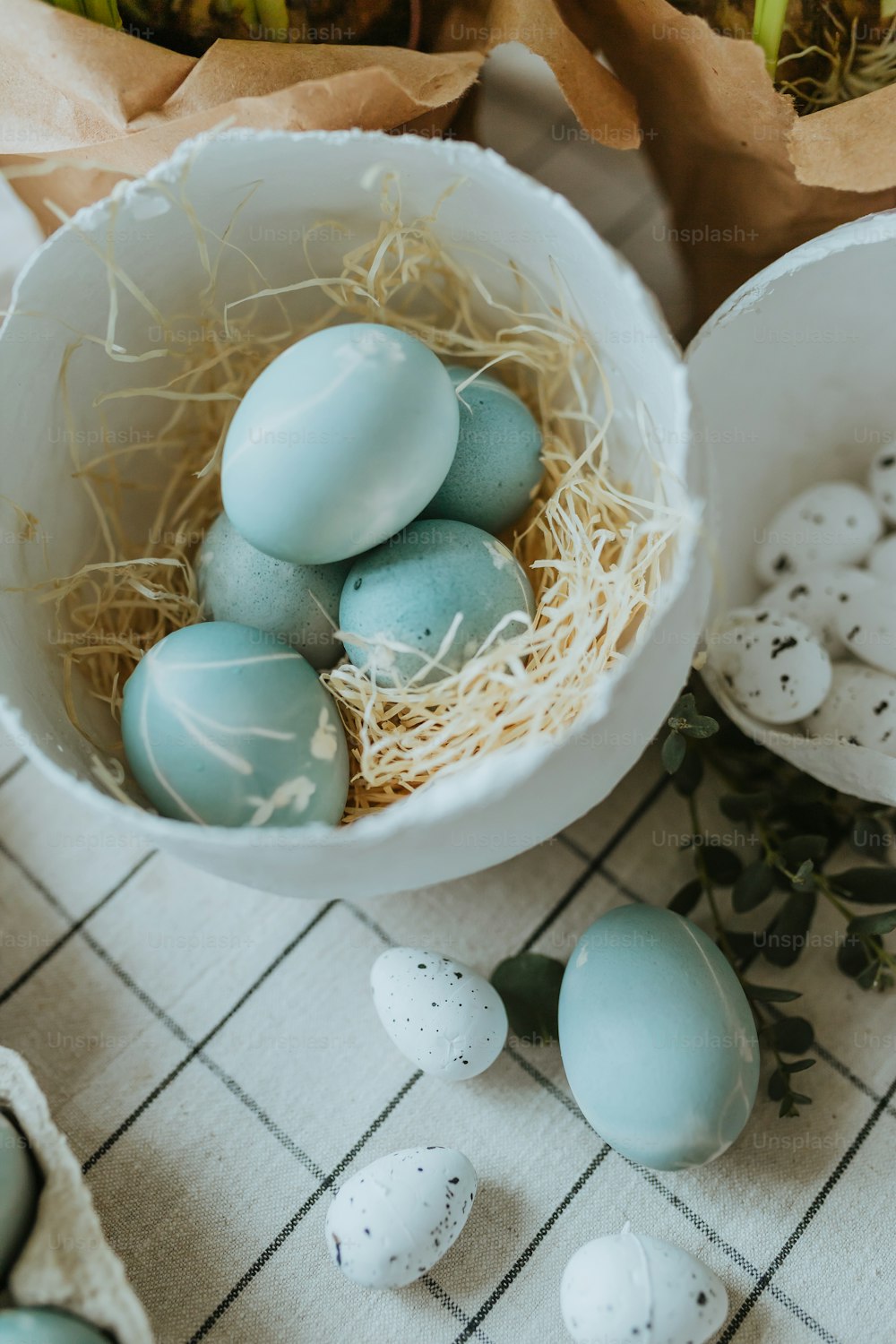 a white bowl filled with blue and white eggs