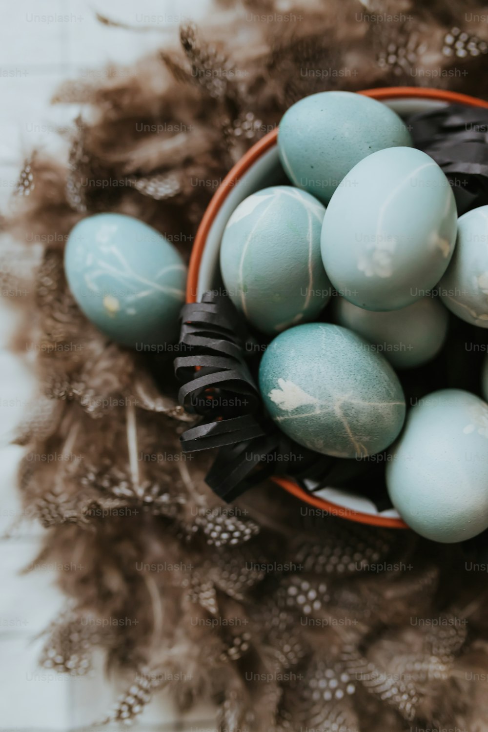 a basket filled with lots of blue eggs
