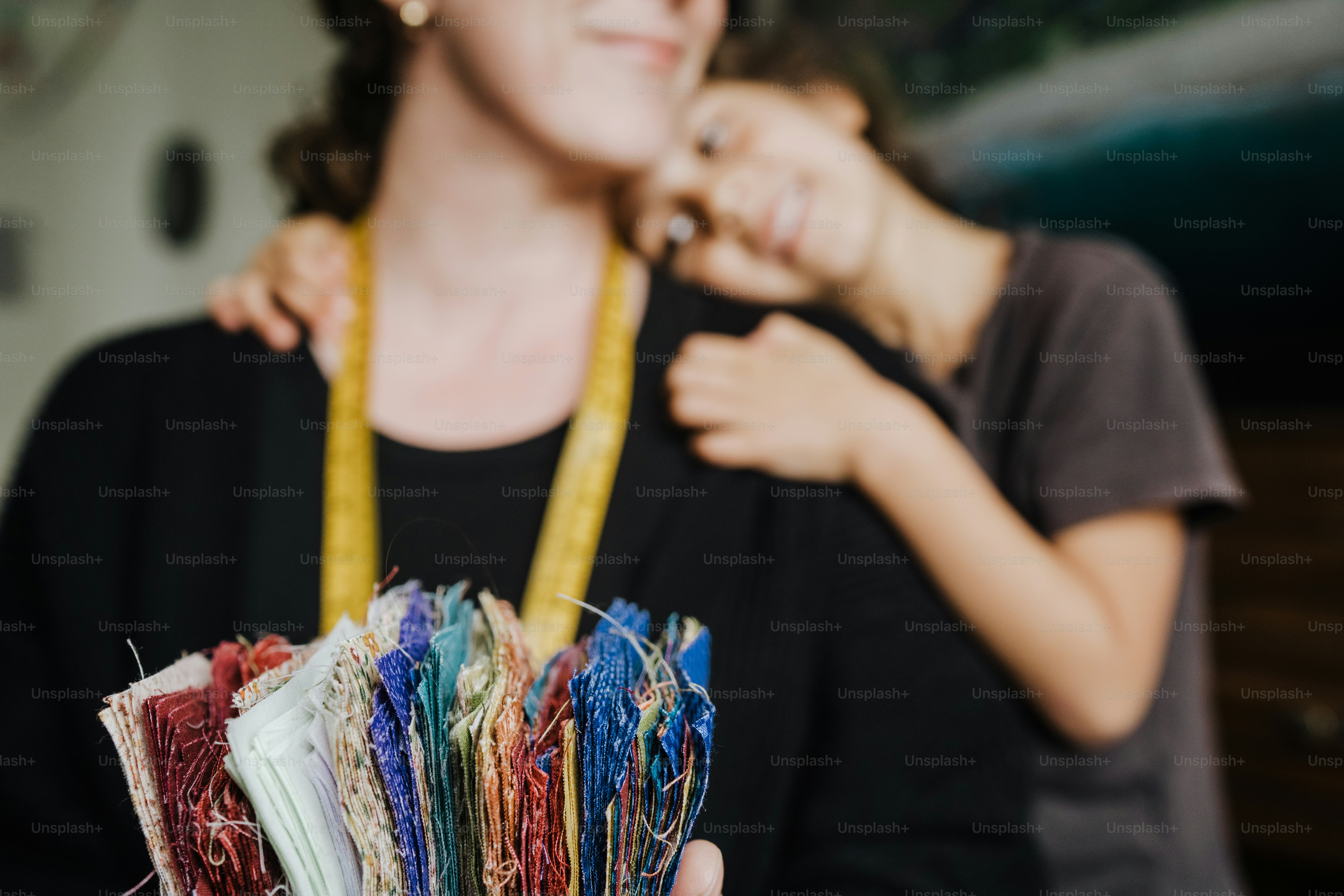 a woman standing next to a woman holding a necklace