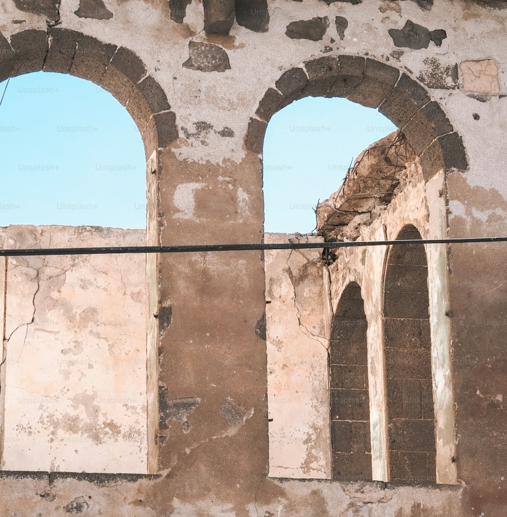 an old building with two arched windows and a power line