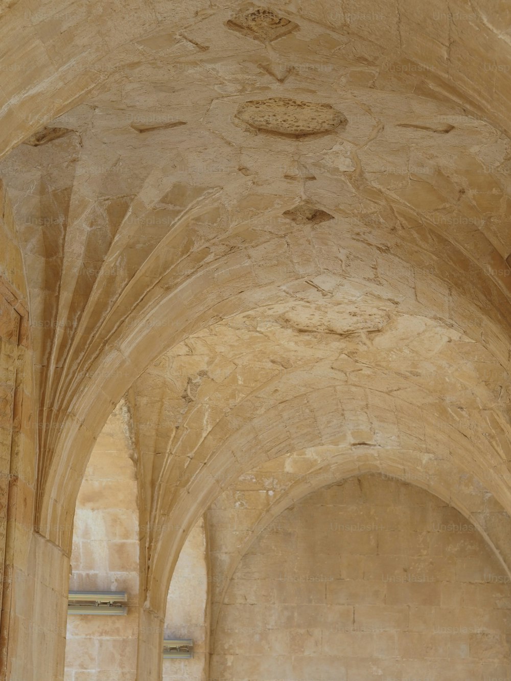 a large stone building with a clock on the wall