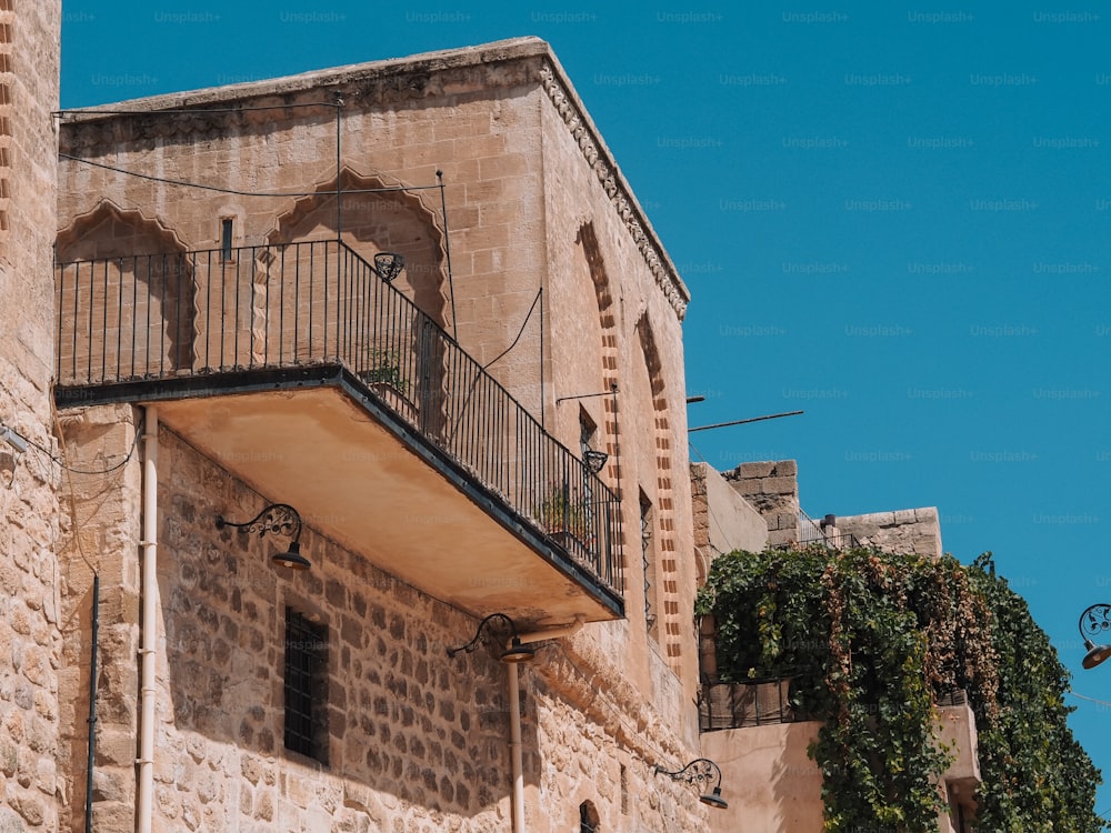 an old building with a balcony and a clock