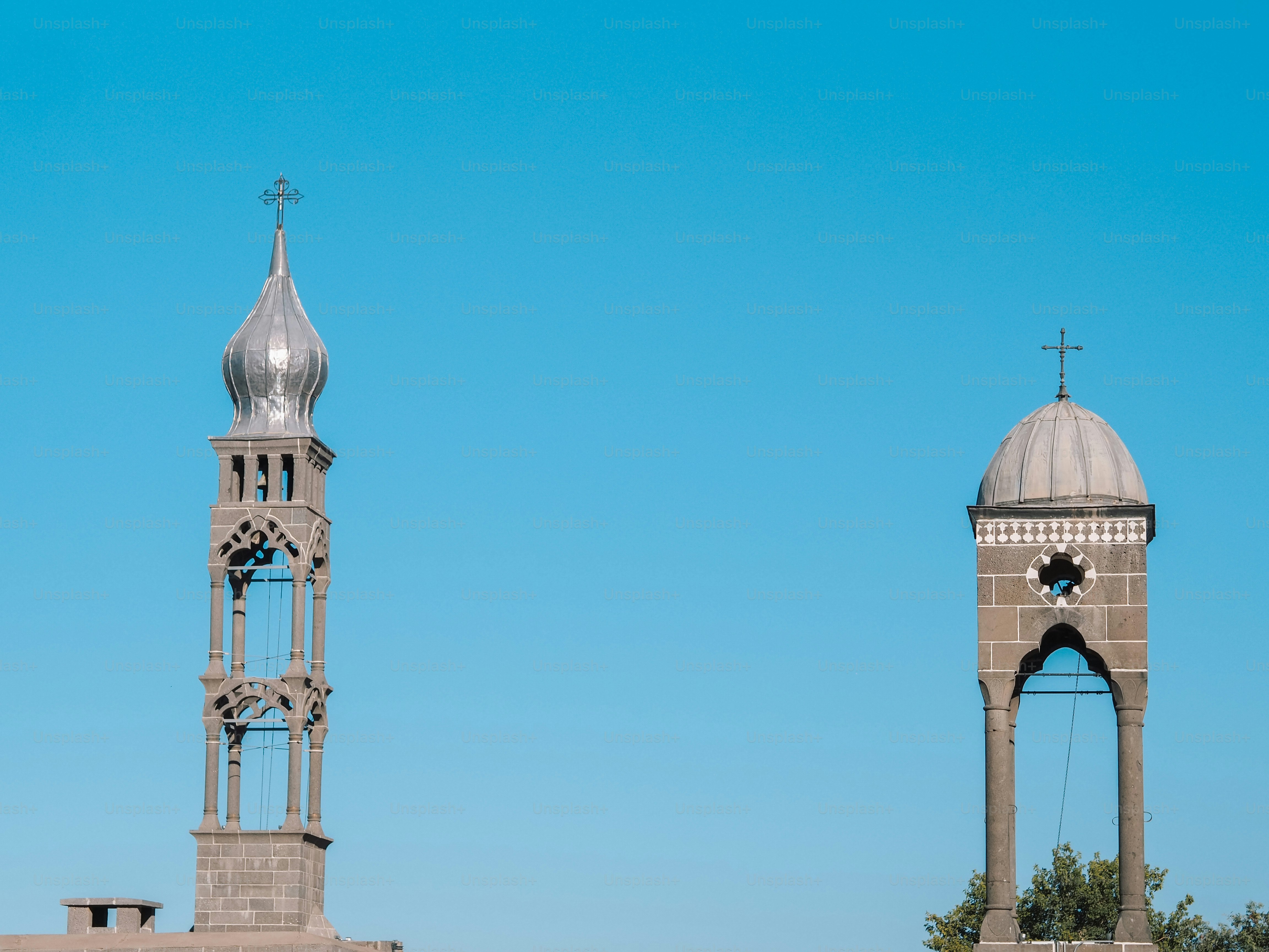 a tall tower with a cross on top of it