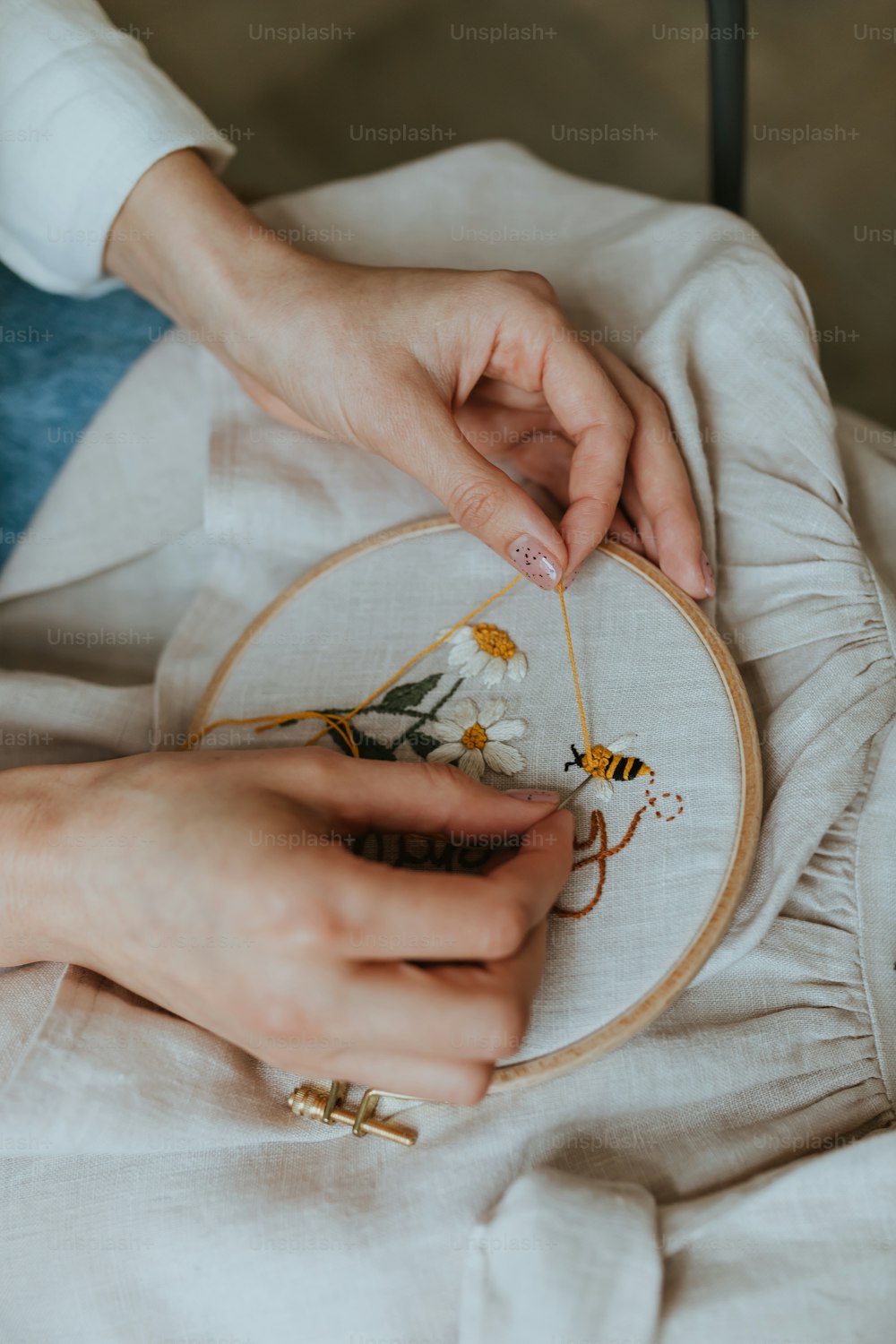 a close up of a person working on a embroidery