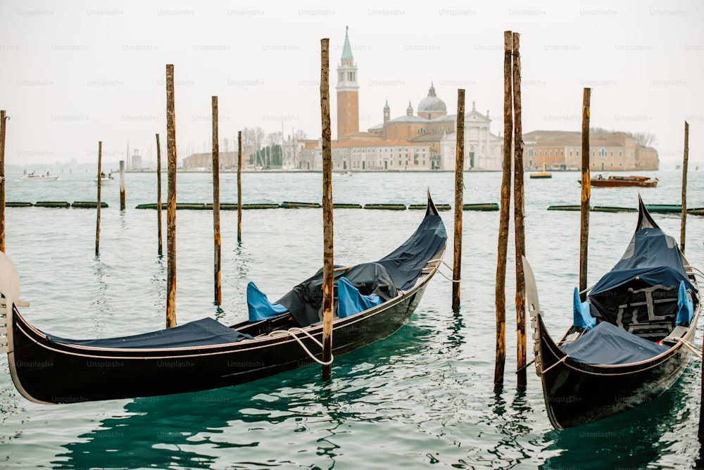a couple of gondolas that are sitting in the water