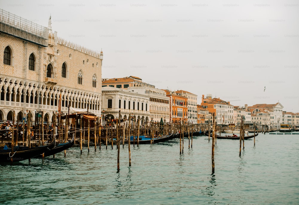 a row of gondolas sitting next to a tall building