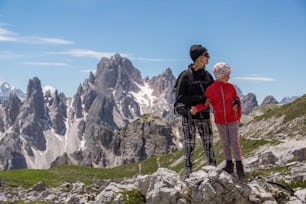 a couple of people standing on top of a mountain