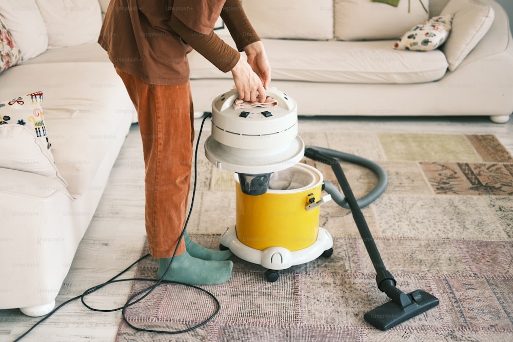 a woman is using a vacuum cleaner on the floor