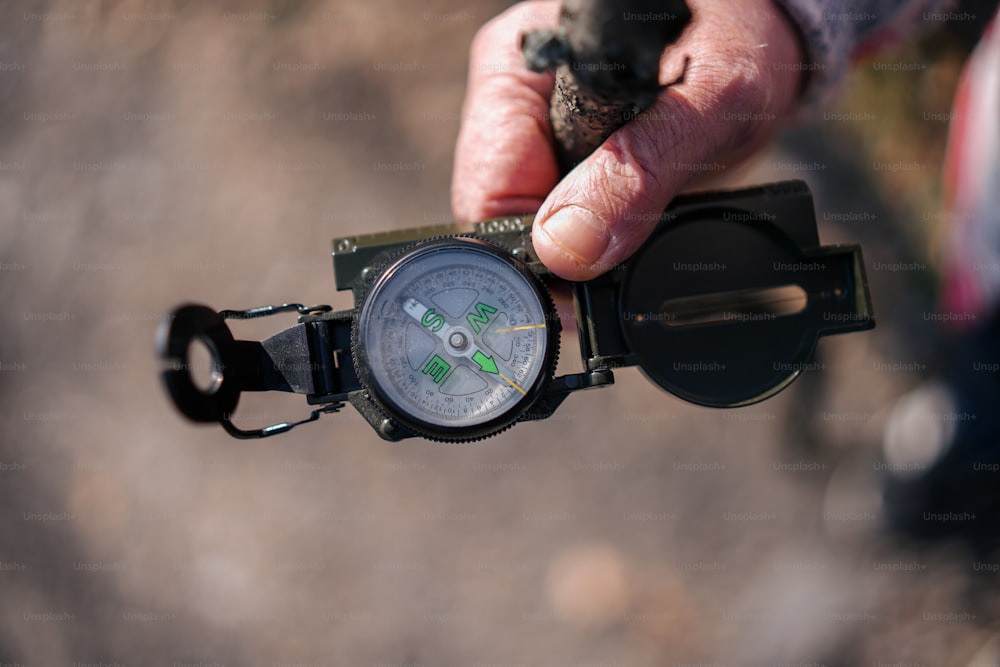 a close up of a person holding a compass