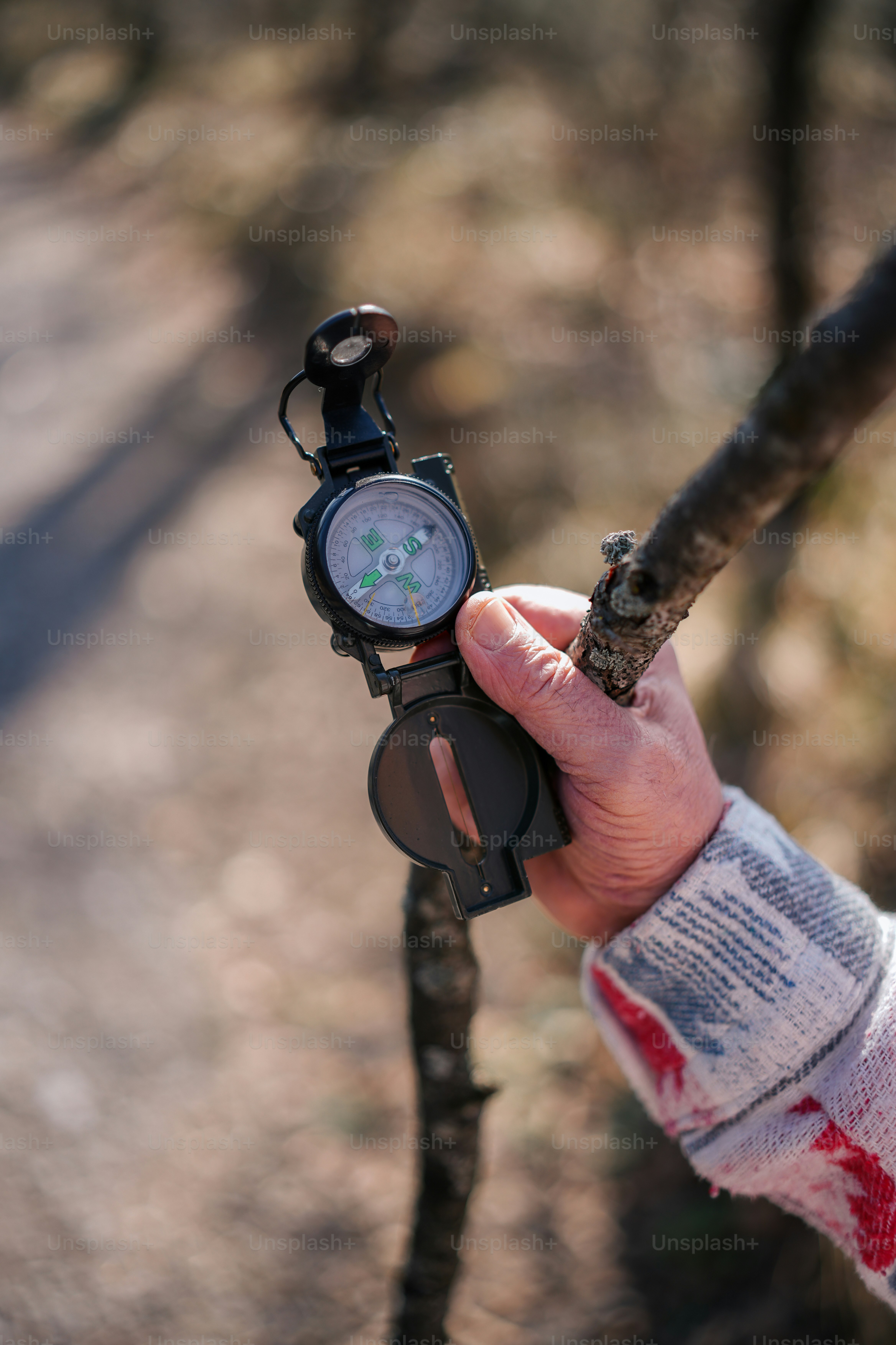 a person holding a compass in their hand