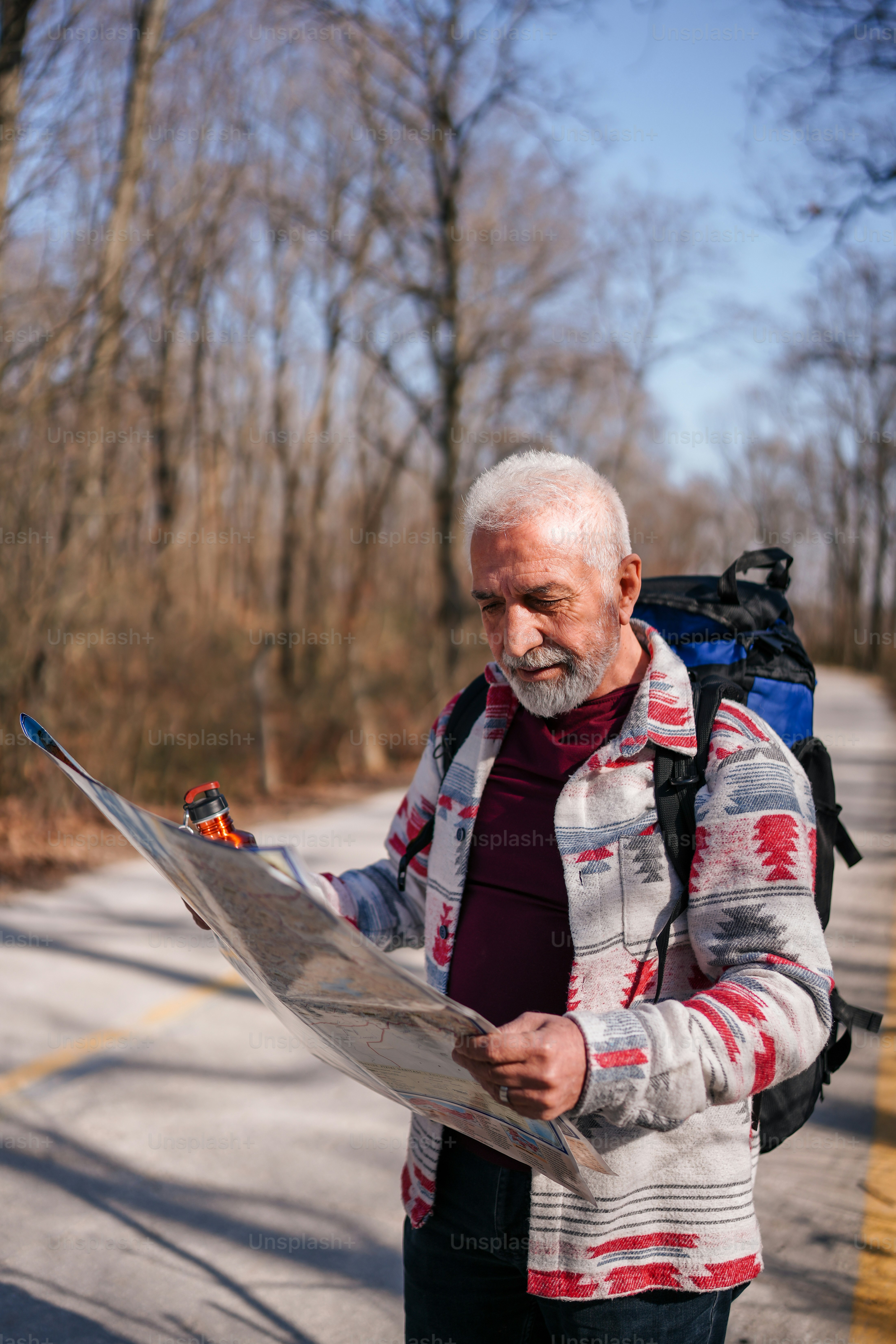 Un homme avec un sac à dos regardant une carte