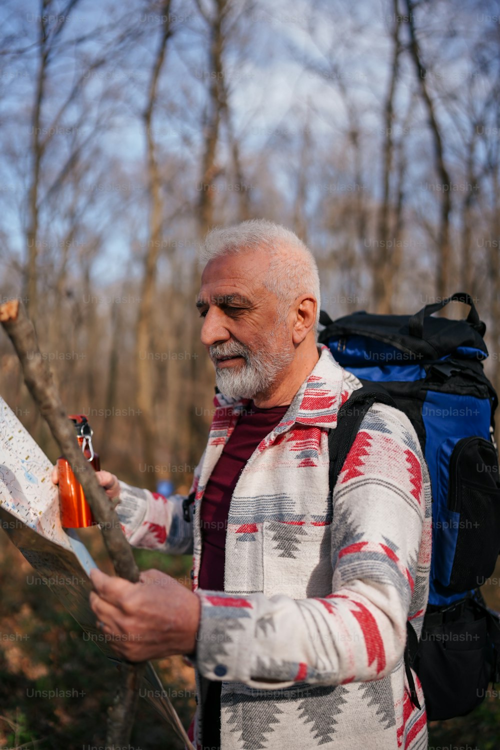 Ein Mann mit einem Rucksack schaut auf eine Karte