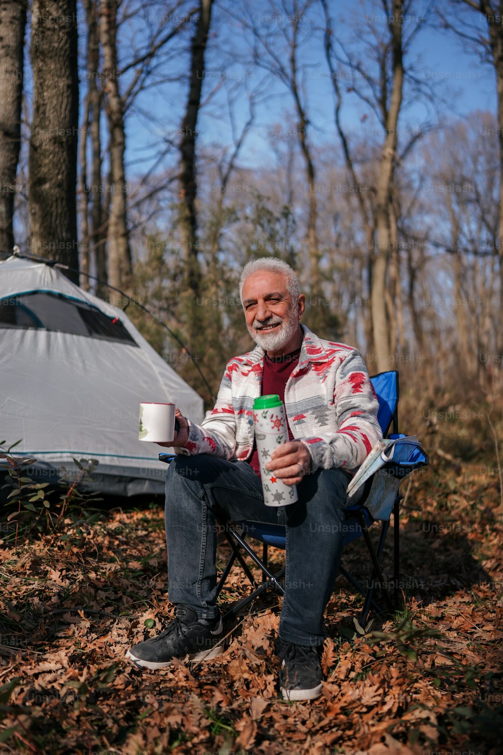 a man sitting in a chair with a cup of coffee