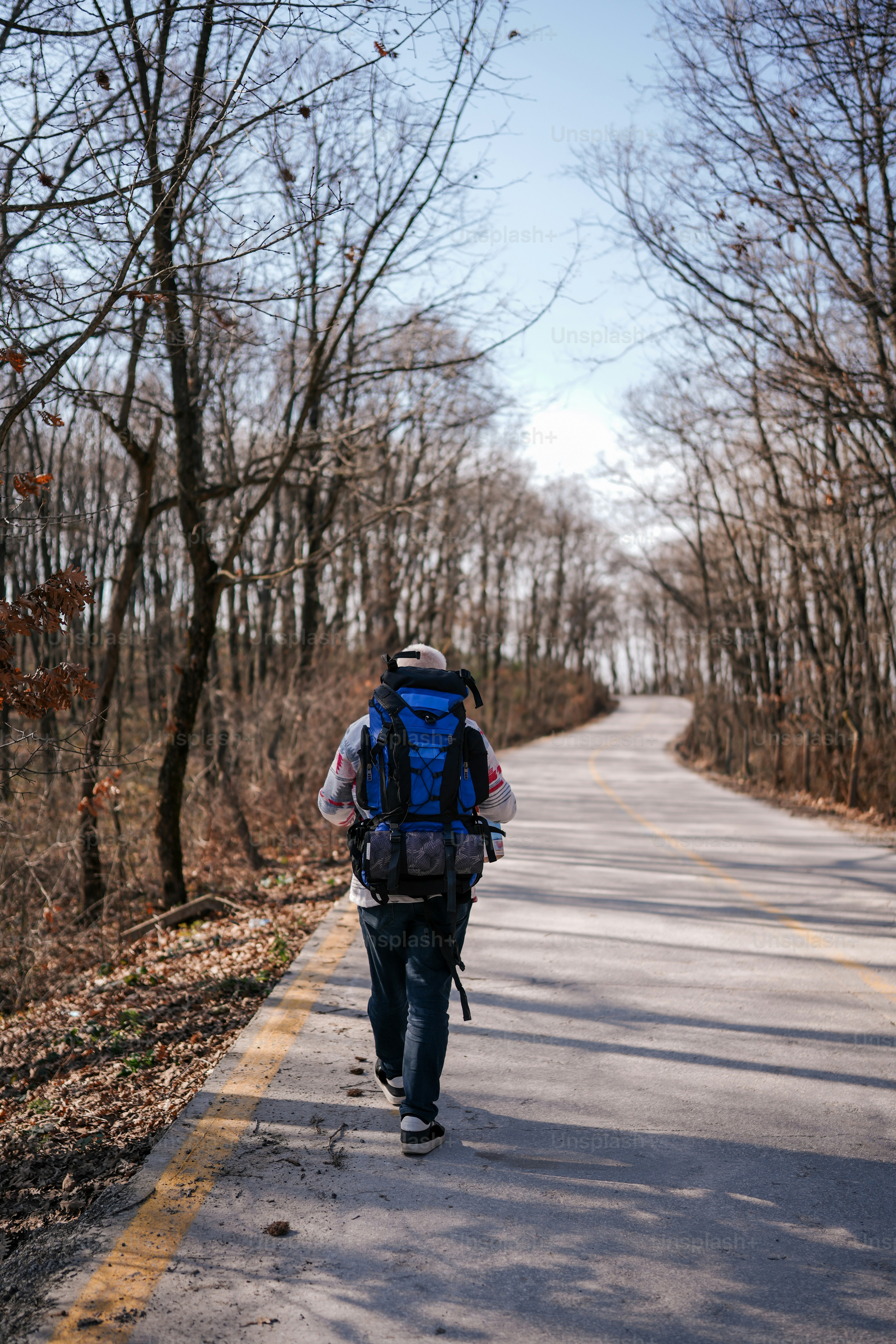 a person with a backpack walking down a road