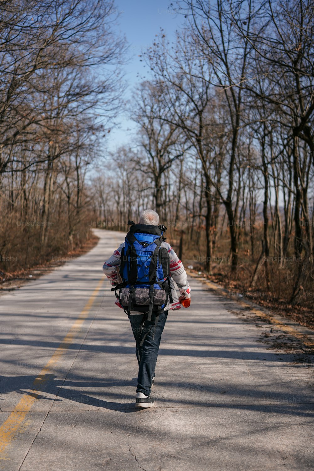 a person with a backpack walking down a road
