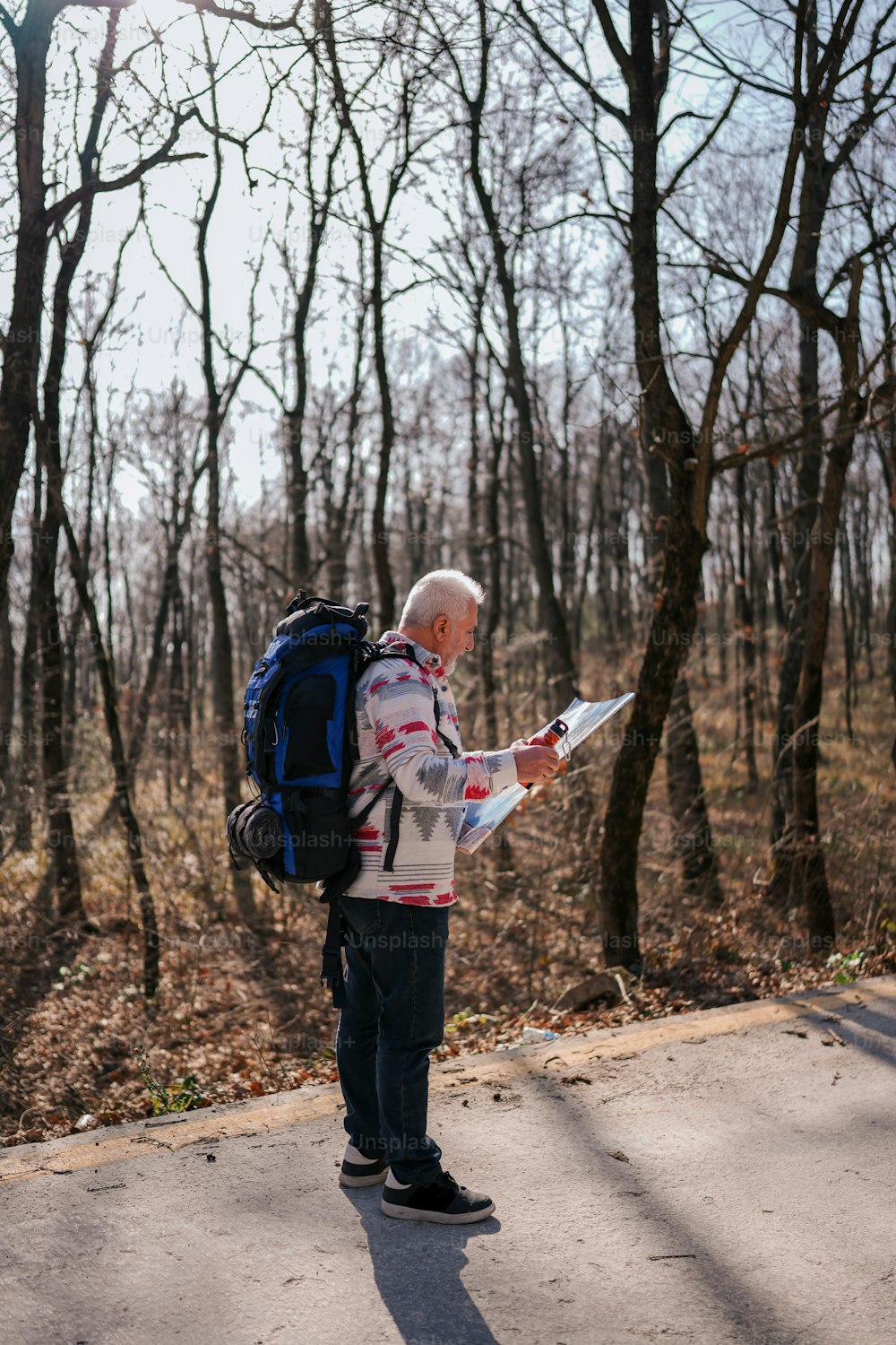 a man with a backpack looking at a map