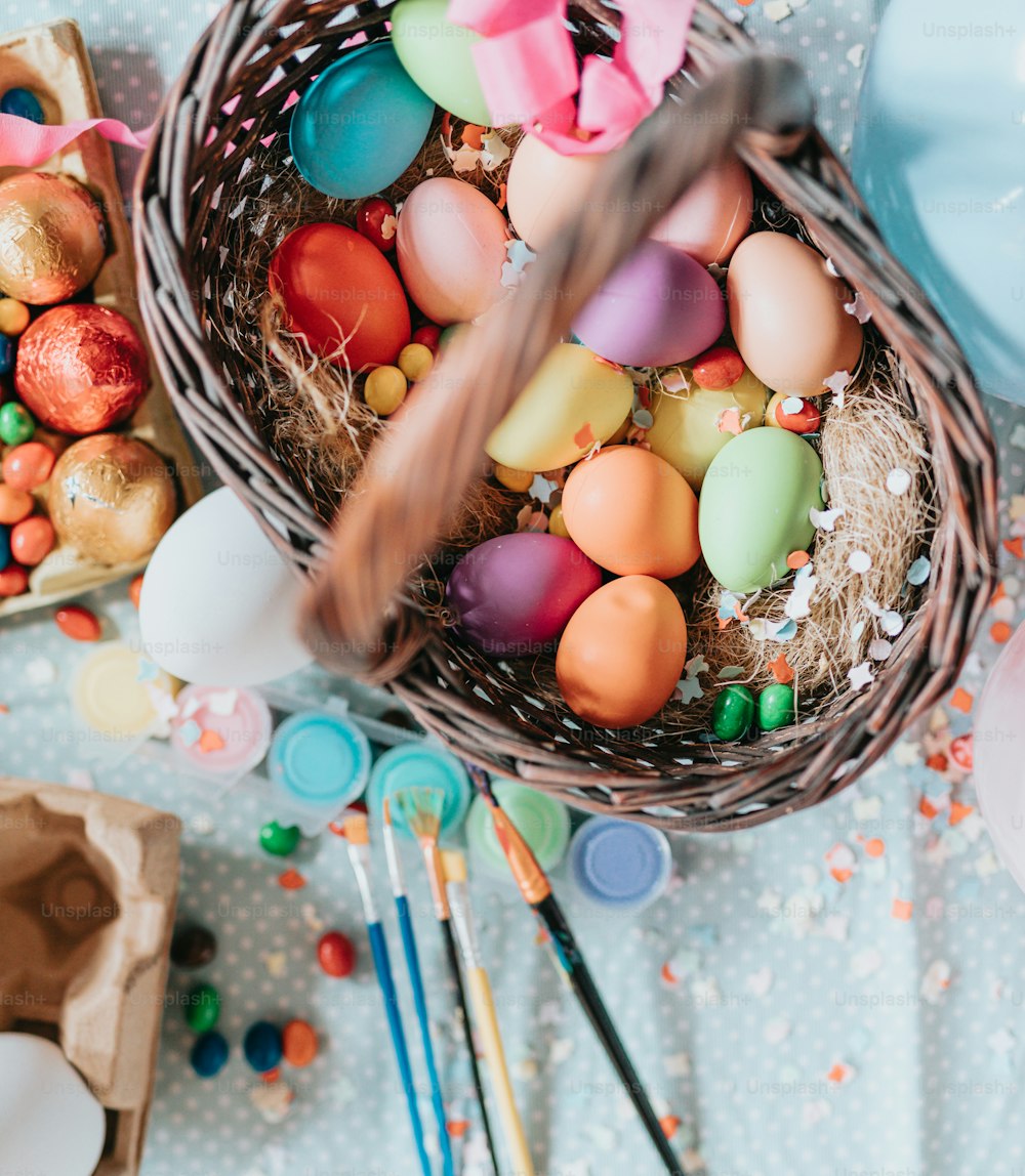 a basket filled with lots of different colored eggs