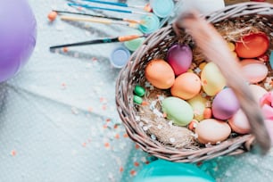 a basket filled with lots of colorful eggs