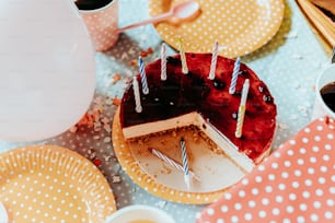 a table topped with plates and a cake